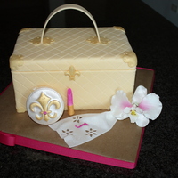 Luggage Bag Cake With Accessories Cake is covered in fondant and all accent pieces (handkerchief, mirror compact and lipstick) are made out of 50/50. Orchid is made out of...