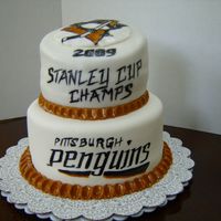 Penguins Win! Surprise cake for my boss, HUGE Penguins fan. Bottom tier is covered in fondant, but top tier is Rolled Buttercream (first time using it)....