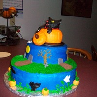 Cat In The Pumpkin The pumpkin and cat are both made of rice krispie treats covered in fondant.