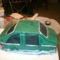 First Car Cake Minus The Wheels first layer chocolate,second layer pina cola buttercream icing cover with fondant