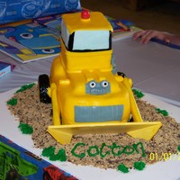 Dozer Cake Loved doing this cake! All fondant (except bucket - cake board) with graham cracker, granola dirt!
