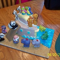 Noah's Ark Covered with fondant. The animals are the Fisher Price toys. The board was done with graham cracker and piping gel. Thanks for looking