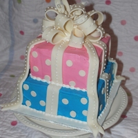 Polka Dot Reveal Cake 8" and 6" square blue-colored vanilla cake. MFF bow and RI dots. Client is having her son cut into it at a Reveal Party with...