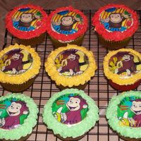 Curious George vanilla cupcake with edible image and buttercream icing.