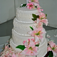 Cascading Lillies This is an 8 inch, 10 inch, 12 inch, 14 inch round tiered cake covered in Michelle Foster's Fondant. The leaf pattern was drawn by...