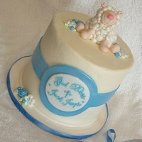 Little Lamb Of God 6 inch triple layer chocolate cake. Iced in white butter cream. Fondant lamb, flowers, band and lable decorate this cake. I used pearl dust...