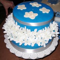 Bridal Shower Cake This was the first cake I ever made. The top flowers are made from fondant and the other flowers are silk.