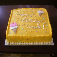 Ice Cream Themed Cake Yellow Buttercream cake with Fondant accents. Chocolate fudge filling