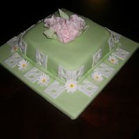 Spring Fantasy Cake Mint green fondant with gumpaste flowers. Devils food cake with chocolate fudge filling.