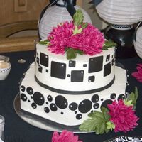 Circles N Squares This ia a buttercream covered cake. Hexagon shaped bottom and round top. It was my first try using modelling chocolate. I used modeling...