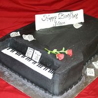 A Grand Affair All buttercream with fondant sheet music and miniature roses.