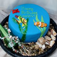 Message In A Bottle This is a 10" two layer chocolate cake with white BC and MMF. All the decorations on the cake itself are MMF except the translucent...