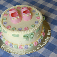 Buttons, Bows, & Twinkle Toes Thats what little girls are made of! 8 inch pineapple cake with buttercream. Gumpaste shoes, fondant bows and buttons.