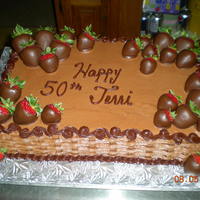 Chocolate Decadence Birthday Cake this is a chocolate cake with chocolate buttercream and strawberry filling adorned with chocolate covered strawberries.