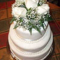 60Th Diamond White Anniversary 3 Tiered Chocolate Cake, filled and iced with buttercream, covered with white fondant, brushed with pearl dust, and accented with ribbon,...