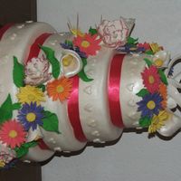 Gerber Daisy And Calla Lilly Wedding Cake Wedding cake with gumpaste Gerber Daisies and Calla Lillies. Forgive the toothpicks. I took this picture at home while the RI was setting....