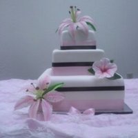 Hibiscus And Lily Wedding Cake 16, 12, and 8 inch squares covered in MMF, satin ribbon, gumpaste star gazer lily and hibiscus.