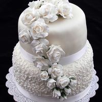 First Wedding Cake Course 3 Stacked Cake Final WASC. 6" Top layer has lemon filling;8" bottom layer has raspberry cheese filling. Gumpaste roses, homemade fondant, RI cornelli...