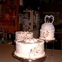 Mccann's 50Th Anniversary My first big project. Six inch and 10 inch cakes are white with white buttercream and the 8 inch is chocolate with white buttercream....