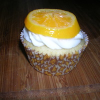 Orange Cupcakes made for my mom"s birthday. they are orange vanilla bean cupcakes with vanilla bean buttercream topped with a candied orange slice.