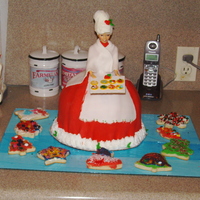 Mrs Claus Welcomes You I made it as a center piece for a Christmas dinner. First attempt at a doll cake. She is mainly fondant with BC accents and hair.