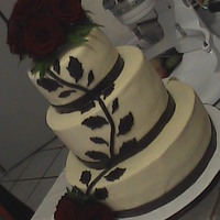 Brown Branch And Leaves Wedding Cake Rum ponque, rum buttercream, chocolate fondant decorations and natural red rose. The filling is dulce de leche with cream cheese rum..