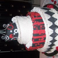 Hpim5833.jpg topsy turvy cake and the bride left it for me to make the design.she wanted funky and different. and she loved it! the second layer is a...