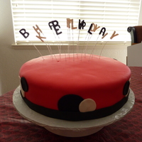 Polka Dot Cake 12" round cake covered in pink fondant with black fondant bottom border and fondant circles. Letters made out of gumpaste painted...