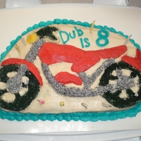Motorcycle Birthday Cake Not pleased with this one, but was really short on time. Didn't have no taste coloring, so I tried to use black sugar for the tires,...