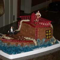 Pirates Of The Carribean Chocolate cake carved into shape of the Black Pearl. railings and figures are not edible. The Kraken tentacles are thick molded BC. Cannons...