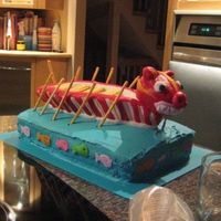 Dragon Boat Cake Made for a dragon boat BBQ party. Boat is made from rice cereal treats, BC, and MMF. Cake is chocolate and covered in BC.