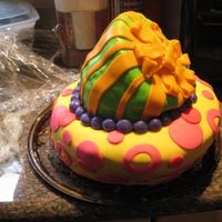 First Topsy Turvy Cake Made for my friend's surprise birthday party. Chocolate cake covered in buttercream frosting and MMF. Decorations are made from MMF.