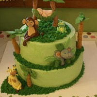 Jungle Themed Baby Cake Jungle Themed Baby Cake based on the decorations and beddings for the expected arrival! Buttercream frosting with gumpaste decorations.