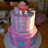 Dora Cake not the best picture in the world... Fondant Dora, and accents on an 8" and 6" cake