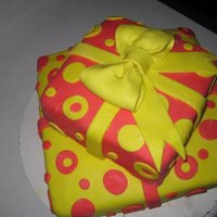 Yellow And Red Presents A half yellow half chocolate cake with buttercream and covered with MMF I made for a friend's birthday.