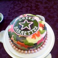 Green Barrettes Camo Cake This was a cake I made for my roller derby team, the Green Barrettes. It's a yellow round cake with buttercream and covered with MMF....
