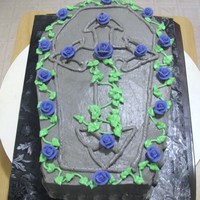 Coffin This is a chocolate cake with oreo buttercream filling. Royal icing roses.