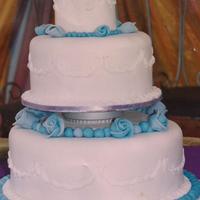 Blue Roses Wedding Cake Three tier round pound cake with fondant covering and fondant roses.