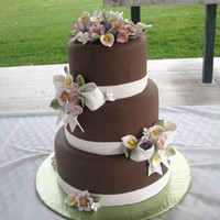 Jessica's Wedding Cake Chocolate fondant covered cakes with gumpaste flowers and bows.