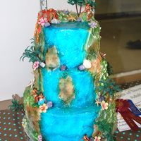 Hawaiian Waterfall This cake is covered in fondant with royal icing and fondant decorations. The cake was airbrushed and the waterfall had piping gel on it to...