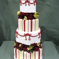 Garden Orchid Cake This is a fondant cover cake with orchids and dark red blossems.