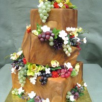 Grape Vine Cake this is a topsy turvy cake with marbleized fondant to give it a wood look. In between each layers there are grapes and orchids and a...