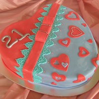 21St Heart Chocolate cake filled and covered with chocolate ganache, then covered in fondant with fondant decorations.