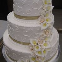 Hearts 6", 10", 12" layers. Candy flowers. Hearts and dots all piped in buttercream.