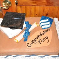College Graduation Yellow (box) cake with chocolate crusting BC (serious_cakes recipe) Fondant diploma, school emblem, tassel and decorations. Mortarboard is...
