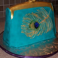 Peacock Feather Purse The client sent me a photo of a purse with a stitched peacock feather. I bounced around a few different ideas on how to achieve the feather...