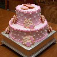 Flower Cake Cake was made for twin baby girls. Pound cake withbutter cream icing. Cookie accents with royal icing.