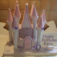 Castle Cake Made for my grandaughter's 6th birthday today. Cake is 2 tiered round madeira. The towers are Wilton and the turret tops, door and top...