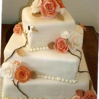 Coral/ivory Wedding Kake Three-tier turned squares with Coral/Ivory roses