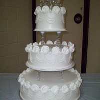 Rosette Wedding Cake Three tier cake, iced in buttercream with royal icing and fondant decorations.